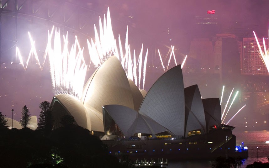 Fireworks explode off the Sydney Opera House at midnight, ushering in the new year