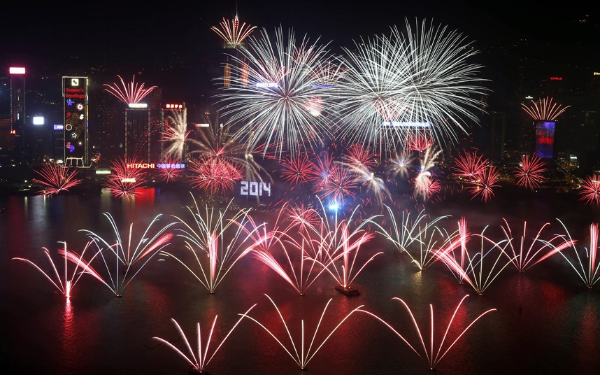 Fireworks explode at the Hong Kong Convention and Exhibition Centre over the Victoria Harbor during New Year's Eve