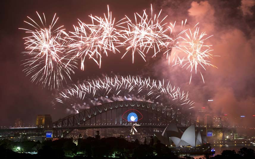 Fireworks light up the sky from the Sydney Harbour Bridge at midnight during New Years Eve celebrations in Sydney, Australia