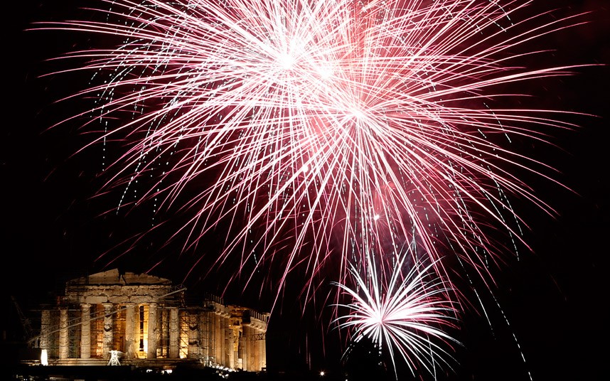 Fireworks explode over the ancient Parthenon temple at the Acropolis Hill