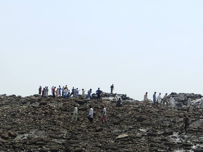 Locals climb to the top of the new Island.