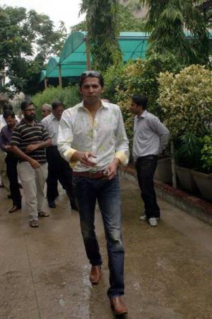 Pakistani cricketer Mohammad Asif arrives for a press conference